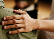 Person providing a supporting arm to a grieving person